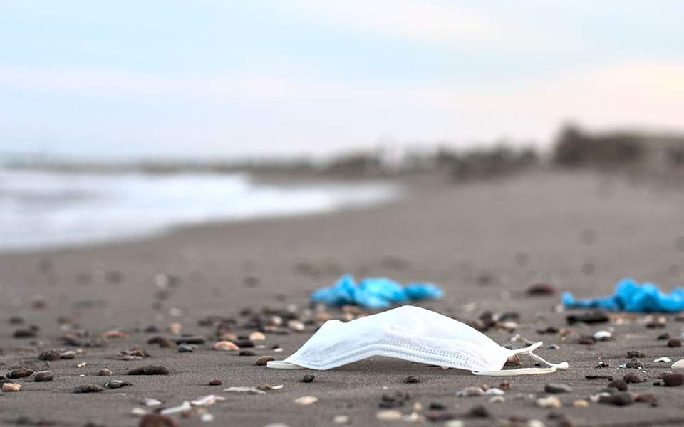 book2sail-COVID 19 mask on a beach