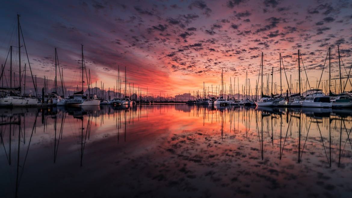 How Much Money Do You Need To Live on a Sailboat? 1 book2sail-sailbats and outstanding sunset 1170x659 1