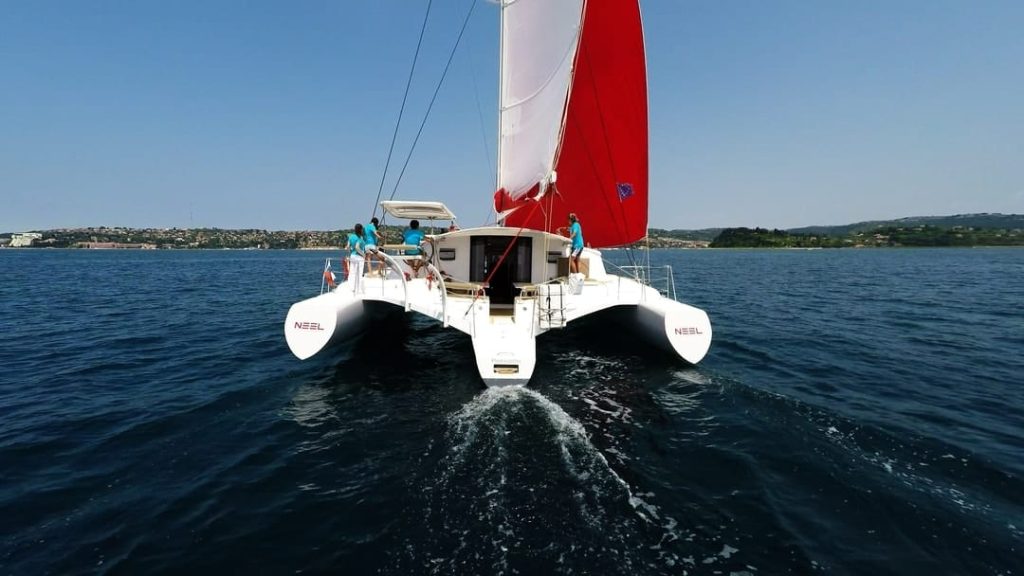 Why we love Catamarans 3 book2sail-stern view of trimaran multihull yacht sailing mi9n